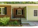 Inviting covered front porch with brick accents, black shutters, and a welcoming entrance, number 1740 displayed at 1740 Fairbanks Sw St, Atlanta, GA 30310