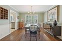 Elegant dining room showcasing hardwood floors, wainscoting, a modern light fixture, and a view into the kitchen at 2789 Townley Cir, Atlanta, GA 30340