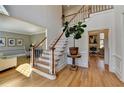 Open foyer showcasing hardwood floors, a staircase with white railings, and views into adjacent living spaces at 210 Eden Bridge Pl, Johns Creek, GA 30022