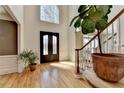 Bright foyer featuring hardwood floors, a grand staircase, and a large window above the front door at 210 Eden Bridge Pl, Johns Creek, GA 30022