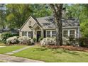 Charming home featuring a landscaped front yard and blooming azaleas beneath the windows at 2370 Hurst Ne Dr, Atlanta, GA 30305