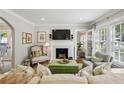 Elegant living room featuring a cozy fireplace and an open layout to the kitchen at 2370 Hurst Ne Dr, Atlanta, GA 30305