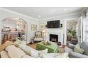 Elegant living room featuring a cozy fireplace and an open layout to the kitchen at 2370 Hurst Ne Dr, Atlanta, GA 30305