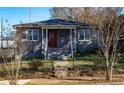 Well-maintained single-story house featuring gray painted brick, a cozy front porch, and a small fenced yard at 60 Cleveland Se St, Atlanta, GA 30316