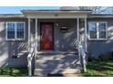 Inviting front porch with white railings and supports, leading to a striking red front door with glass features at 60 Cleveland Se St, Atlanta, GA 30316