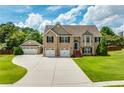 Charming brick home with a three car garage and well maintained lawn at 981 Golden Meadows Ln, Loganville, GA 30052