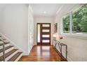 Beautiful light-filled foyer with hardwood floors, statement lighting and staircase at 1155 Mcconnell Dr, Decatur, GA 30033