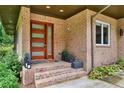 Eye catching front door, brick facade, and attractive plantings complement this home's exterior at 1155 Mcconnell Dr, Decatur, GA 30033