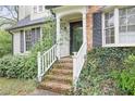 Close up of front porch with brick steps, white railing and lush ivy climbing the brick at 172 Forest Nw Ln, Marietta, GA 30064