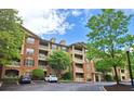 Attractive building exterior with multiple stories and private balconies, surrounded by mature trees at 1910 Cedar Glenn Way # 4104, Atlanta, GA 30339