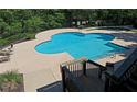 A clover-shaped outdoor pool on a sunny day, surrounded by greenery and lounge chairs at 1910 Cedar Glenn Way # 4104, Atlanta, GA 30339