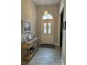 Inviting foyer featuring tile floors, console table, and decorative lighting at 10825 Pinewalk Forest Cir, Alpharetta, GA 30022