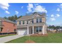 Charming two-story brick home featuring a two-car garage and manicured front lawn at 612 Leafy Branch Way, Mcdonough, GA 30253
