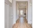 Inviting foyer with durable hardwood flooring, light neutral paint and trim at 612 Leafy Branch Way, Mcdonough, GA 30253