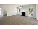 Expansive living room features a cozy fireplace, large windows, and ample space for entertaining and relaxation at 956 Buckhorn Bnd, Locust Grove, GA 30248