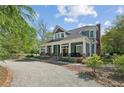 Inviting two-story home featuring a columned front porch and a circular driveway at 1102 Emory St, Oxford, GA 30054