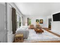 Bright living room featuring hardwood floors, white walls, and large windows at 1685 Carroll Nw Dr, Atlanta, GA 30318