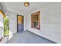 Covered porch with a wooden door and a view of the outdoors at 1685 Carroll Nw Dr, Atlanta, GA 30318