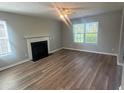 Inviting living room with hardwood floors, a classic fireplace, and large windows providing ample natural light at 2763 Storybook Ct, Grayson, GA 30017