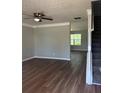 Bright and spacious living room featuring a ceiling fan, hardwood floors, and neutral paint colors at 2763 Storybook Ct, Grayson, GA 30017