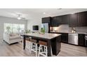 Modern kitchen with granite island, stainless steel appliances, and adjacent living area at 2857 Regal Park # 3, Atlanta, GA 30318