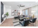 Bright living room with stylish gray sectional sofa, chic decor, and large windows with sheer curtains at 371 Grant Se Cir # 1822, Atlanta, GA 30315
