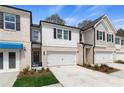 Charming townhomes feature brick accents, individual driveways, and attached garages at 405 Brooch Way, Stockbridge, GA 30281