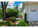 Landscaped garden with a single chair outside of the home's garage at 11050 Linbrook Ln, Duluth, GA 30097