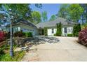 Well-maintained home with mature landscaping, stone accents, and an attached two-car garage at 11050 Linbrook Ln, Duluth, GA 30097