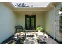 Inviting covered front porch area with slate tile, decorative plants and bench seating at 11050 Linbrook Ln, Duluth, GA 30097