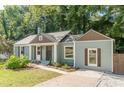 Charming blue home with a well-maintained lawn and inviting entryway, featuring complementary brown trim at 1404 E Forrest Ave, Atlanta, GA 30344