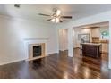 Open-concept living room features dark hardwood floors, fireplace, and seamless transition to the modern kitchen at 1404 E Forrest Ave, Atlanta, GA 30344