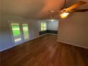 The living room features hardwood floors, a ceiling fan, and natural light with glass paneled doors at 530 Bell Se Rd, Conyers, GA 30094