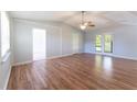 Spacious living room featuring hardwood floors and French doors leading to the backyard at 530 Bell Se Rd, Conyers, GA 30094