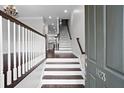 Inviting entryway showcases a staircase with dark wood accents and modern white railings at 1123 Providence Pl, Decatur, GA 30033