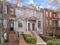 Attractive brick townhomes feature elegant detailing and well-maintained front yards for a welcoming feel at 1123 Providence Pl, Decatur, GA 30033