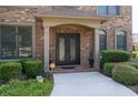 Elegant entryway with double doors and manicured bushes provide a warm, welcoming entrance at 2365 Barrington Trace Sw Cir, Atlanta, GA 30331