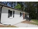 A well-maintained home showcasing a red front door and a freshly painted white brick exterior at 3811 Crosby Nw Dr, Atlanta, GA 30331