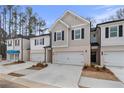 Modern townhome exteriors feature attached garages, neutral tones, and professionally landscaped front lawns at 417 Brooch Way, Stockbridge, GA 30281