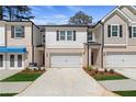 Charming townhome exterior featuring a two-car garage and manicured landscaping at 421 Brooch Way, Stockbridge, GA 30281