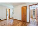 Bedroom featuring gleaming hardwood floors, wood doors, and ample natural light at 5295 Woodland Dr, Lake City, GA 30260