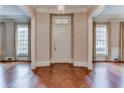 Elegant foyer featuring hardwood floors, a chandelier, and natural light streaming through large windows at 55 Asheworth Ct, Atlanta, GA 30327