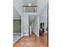 Foyer featuring hardwood floors, natural light, a view of the living space, and a decorative stairway at 907 Fox Croft Pl, Canton, GA 30114