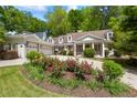 Charming home featuring a meticulously manicured lawn, flower garden, and inviting columned front porch at 998 Ferncliff Ne Rd, Atlanta, GA 30324