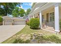 Inviting porch with manicured lawn, brick stairs and walkway, and two car garage at 998 Ferncliff Ne Rd, Atlanta, GA 30324