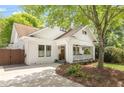 Attractive white brick home with a cozy front porch, fresh landscaping, and a concrete driveway at 224 Kings Hwy, Decatur, GA 30030
