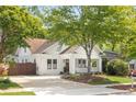 Quaint white home with a welcoming front porch, mature trees, and a charming driveway at 224 Kings Hwy, Decatur, GA 30030