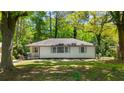 Charming single-story home with a well-maintained front lawn and mature trees at 754 Pinehill Se Dr, Smyrna, GA 30080