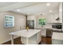 Bright kitchen with island, stainless steel appliances and hardwood floors at 754 Pinehill Se Dr, Smyrna, GA 30080
