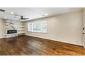 Bright living room boasts hardwood floors, a modern fireplace with shelving, and natural light at 754 Pinehill Se Dr, Smyrna, GA 30080